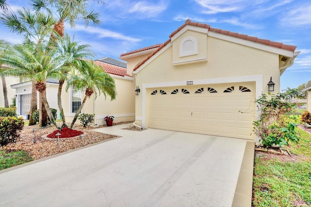 mediterranean / spanish-style house with a garage