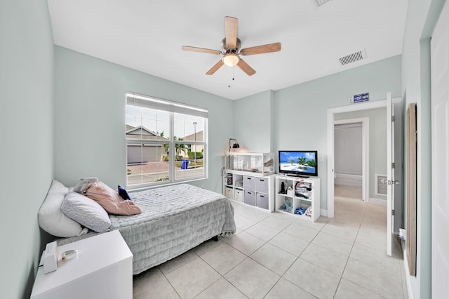 tiled bedroom featuring ceiling fan