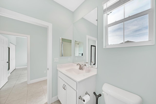 bathroom with vanity, tile patterned floors, and toilet