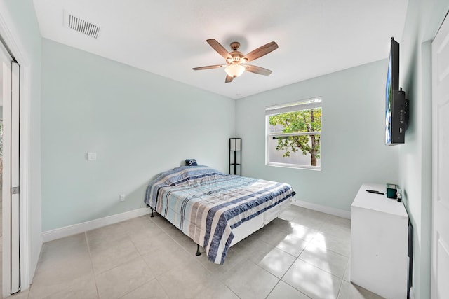 tiled bedroom featuring ceiling fan