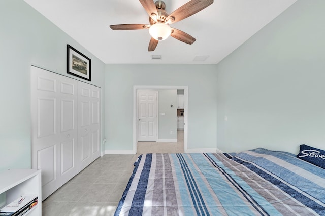 unfurnished bedroom featuring ceiling fan, a closet, and light tile patterned floors