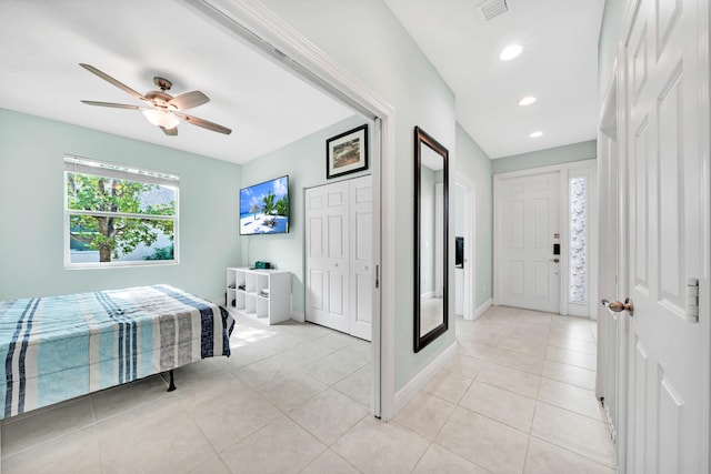 tiled bedroom featuring a closet and ceiling fan