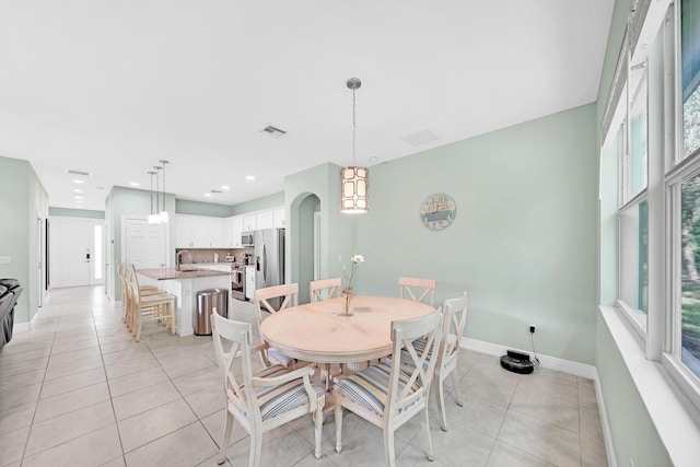 dining area with sink and light tile patterned flooring