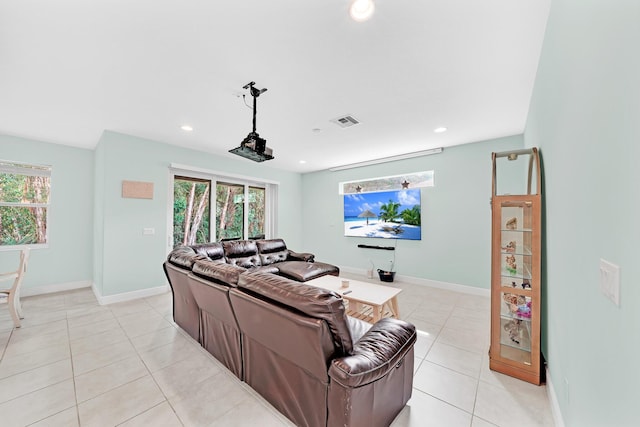 home theater room with light tile patterned floors and a wealth of natural light