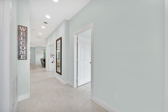 corridor featuring light tile patterned floors