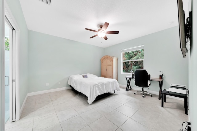 bedroom with ceiling fan and light tile patterned floors