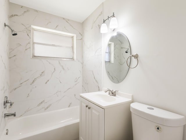 bathroom with toilet, vanity, and shower / washtub combination
