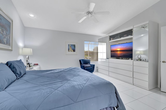 tiled bedroom with lofted ceiling, a textured ceiling, and ceiling fan