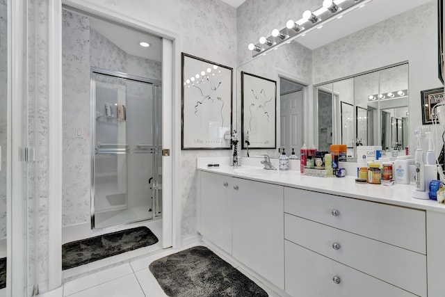 bathroom with an enclosed shower, vanity, and tile patterned flooring