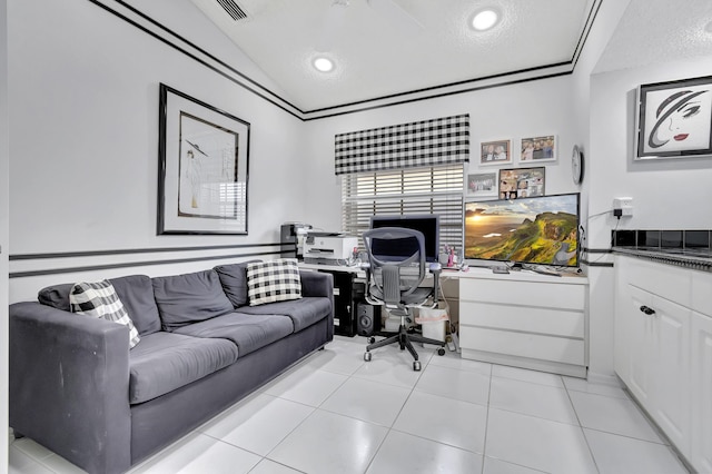 office featuring vaulted ceiling, a textured ceiling, and light tile patterned floors