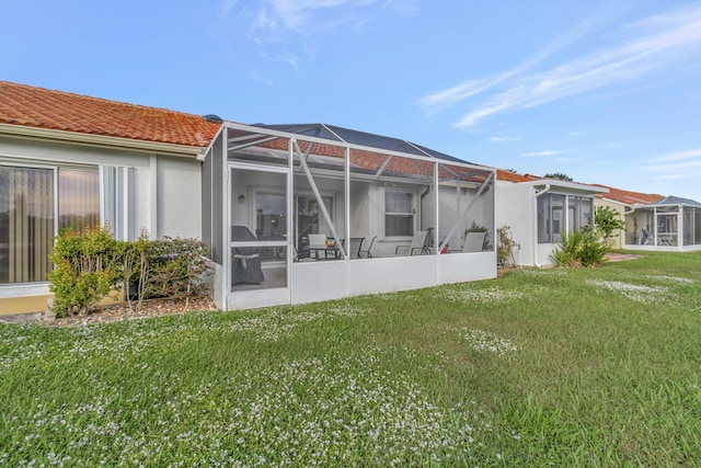 back of property featuring a yard and a lanai