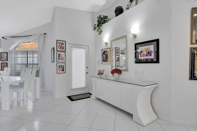 tiled foyer with vaulted ceiling