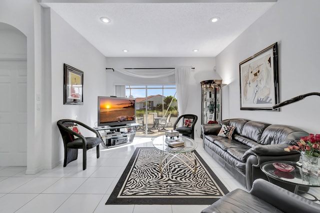 living room featuring light tile patterned floors and a textured ceiling