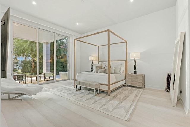 bedroom with access to exterior and light hardwood / wood-style floors