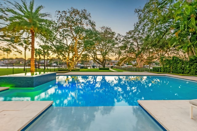 view of pool at dusk