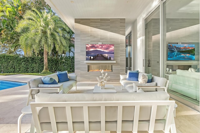 view of patio / terrace with a pool and an outdoor living space with a fireplace