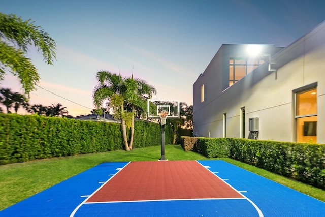 view of sport court with a lawn