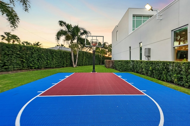 view of basketball court featuring a yard