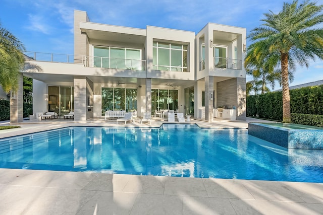 view of swimming pool featuring an in ground hot tub and a patio