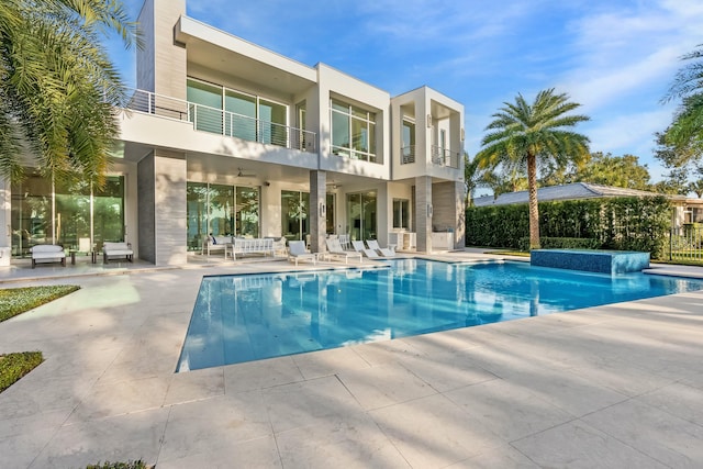 view of pool with pool water feature and a patio area