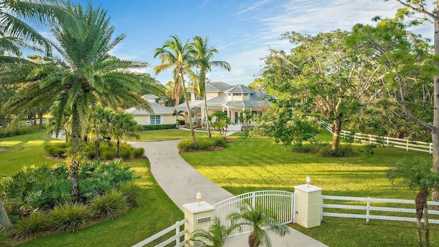 surrounding community with a fenced front yard, a gate, and a yard