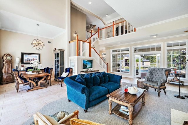 living area with ornamental molding, a high ceiling, stairway, and light tile patterned flooring