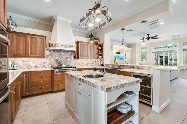 kitchen featuring wine cooler, premium range hood, a sink, appliances with stainless steel finishes, and open shelves