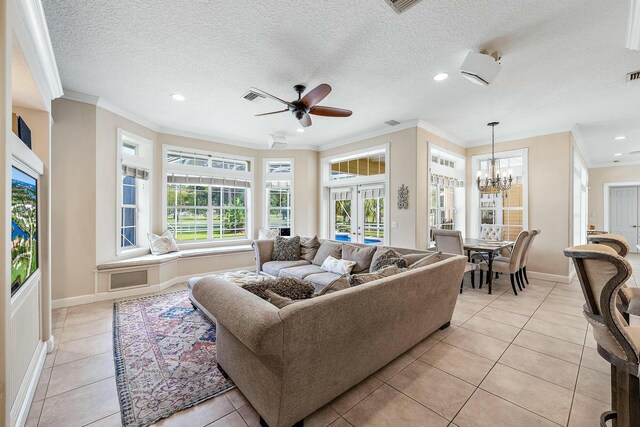 living area with baseboards, light tile patterned flooring, crown molding, and french doors