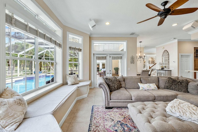 living area with french doors, light tile patterned floors, recessed lighting, ornamental molding, and ceiling fan with notable chandelier