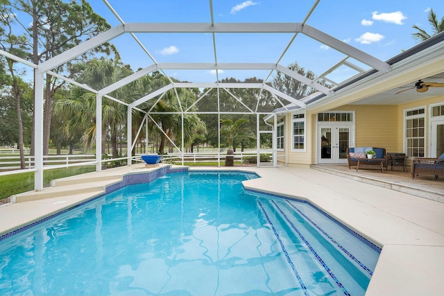 outdoor pool with french doors, a patio, fence, ceiling fan, and a lanai