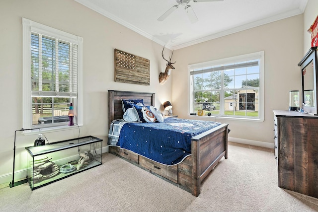 carpeted bedroom with ornamental molding, a ceiling fan, and baseboards