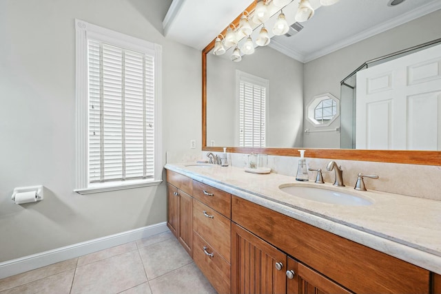bathroom with ornamental molding, tile patterned flooring, a sink, and baseboards