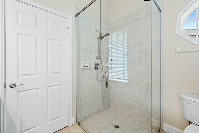 full bathroom with a shower stall and toilet