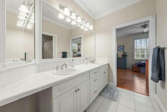 full bathroom featuring double vanity, ornamental molding, tile patterned flooring, and a sink