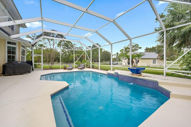 outdoor pool with a lanai, a patio, and grilling area