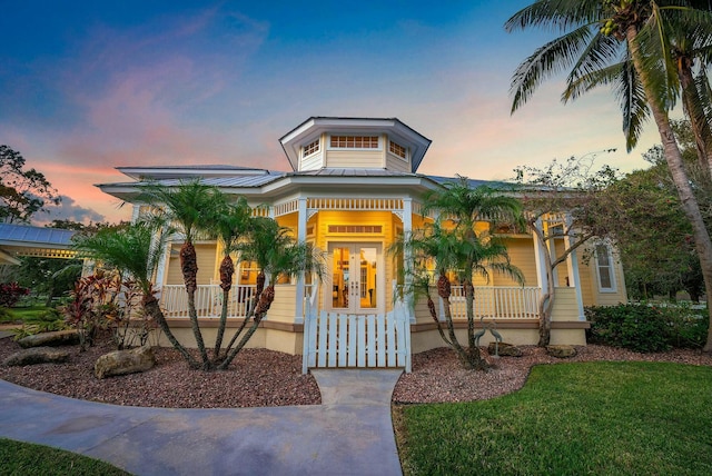 view of front of home featuring a porch and metal roof