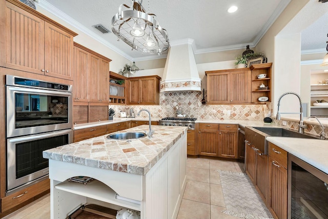 kitchen with stainless steel appliances, custom range hood, a sink, and open shelves
