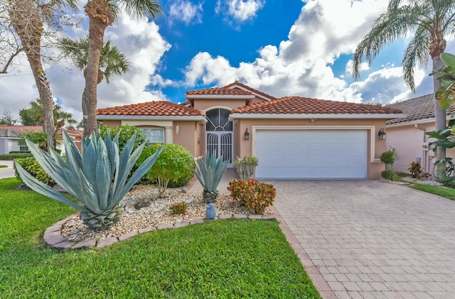 mediterranean / spanish-style house with a garage