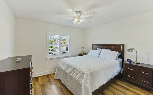 bedroom featuring ceiling fan and dark hardwood / wood-style flooring