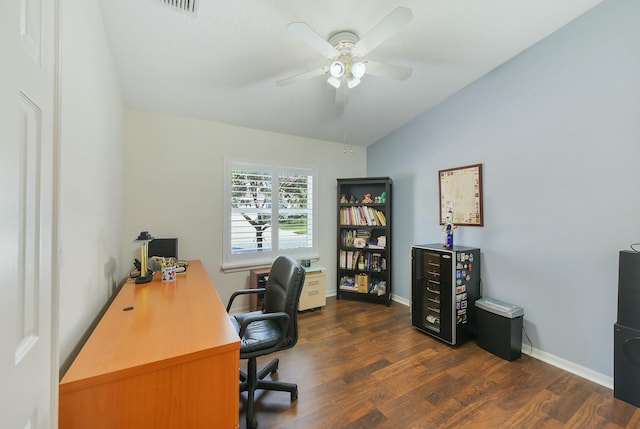 home office with vaulted ceiling, ceiling fan, and dark hardwood / wood-style flooring