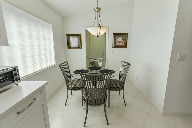 dining room featuring vaulted ceiling