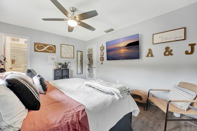 bedroom with ceiling fan, ensuite bathroom, and hardwood / wood-style floors