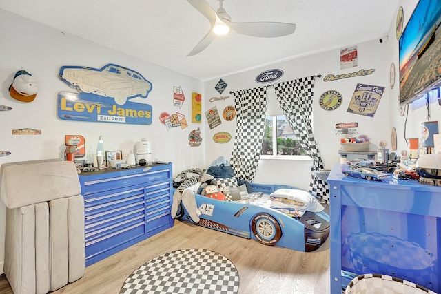 bedroom with hardwood / wood-style flooring and ceiling fan