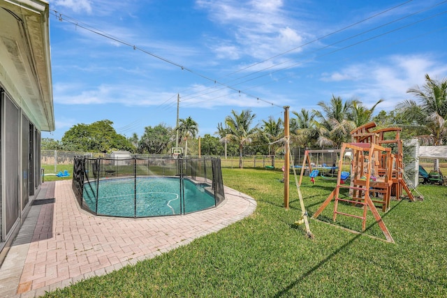 view of pool with a playground and a lawn