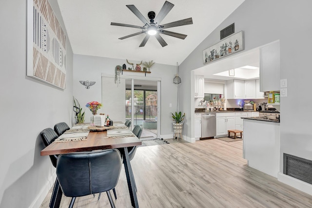 dining space featuring ceiling fan, high vaulted ceiling, and light hardwood / wood-style floors