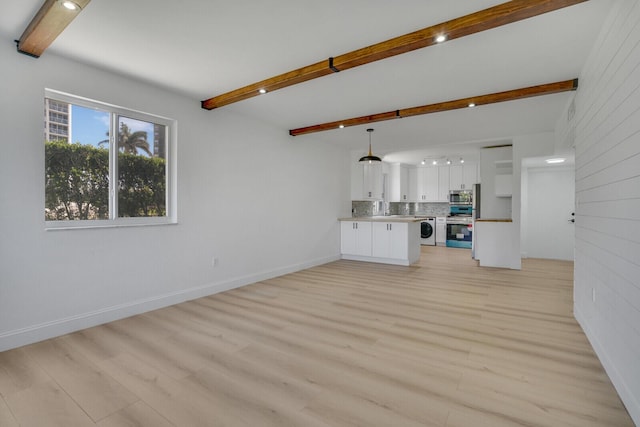 unfurnished living room with light wood-style floors, baseboards, washer / clothes dryer, and beam ceiling