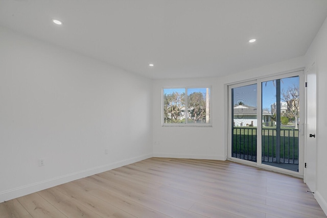 spare room featuring plenty of natural light, light wood-style flooring, and recessed lighting