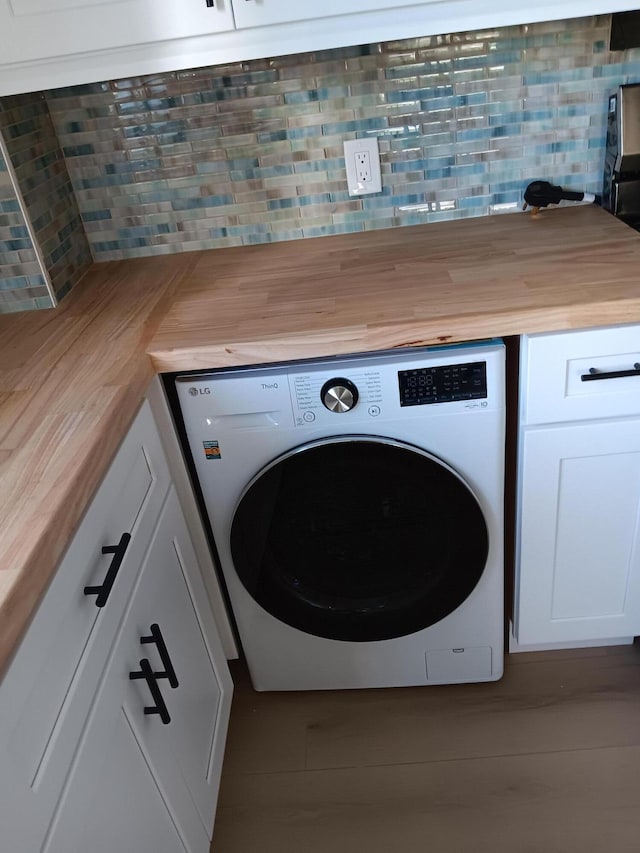 clothes washing area with laundry area and washer / dryer