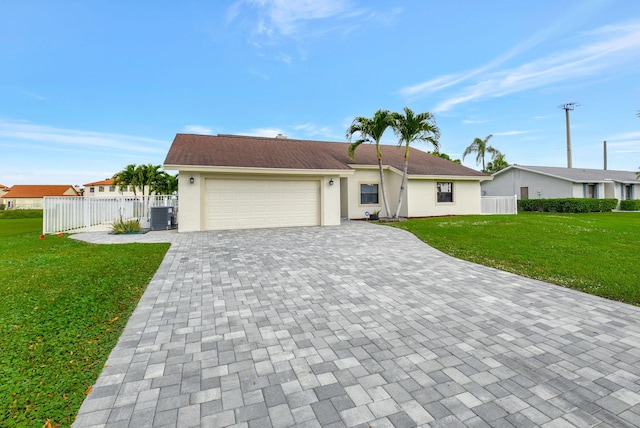 ranch-style home featuring central AC unit, a garage, and a front lawn