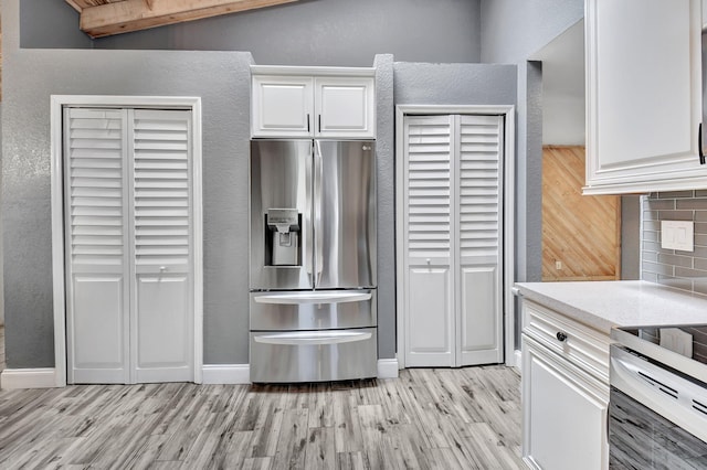 kitchen with tasteful backsplash, stainless steel fridge with ice dispenser, light hardwood / wood-style floors, and white cabinets